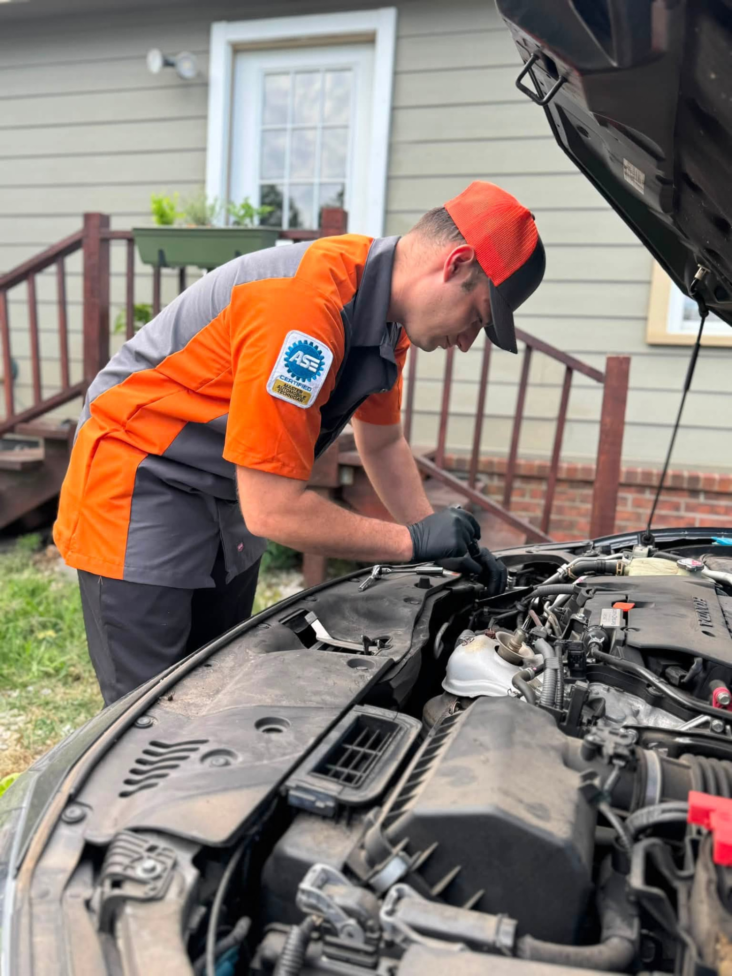 Jacob Sullivan, ASE Master Certified mobile mechanic in Northwest Arkansas, running diagnostics under a vehicle hood